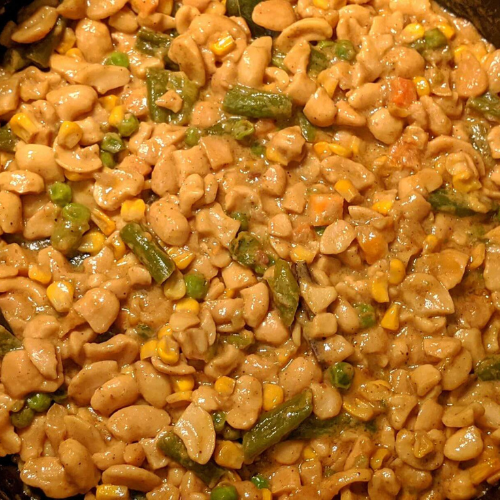 Cashew curry with mixed vegetables such as carrots, green beans and peas