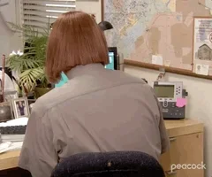 gif of dwight from the office tv show wearing a red short wig