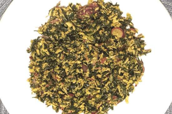 Cabbage leaves shredded and fried on a white plate
