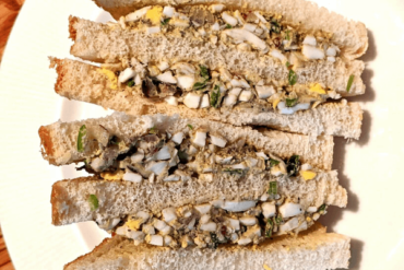 Egg salad sandwiches on a white plate