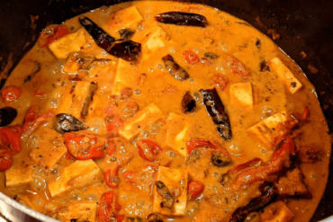 Paneer cubes in a coconut curry with tomatoes and spices