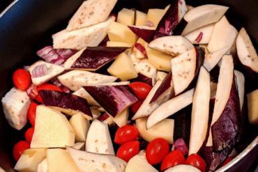 chopped aubergine, potatoes and tomatoes in a saucepan