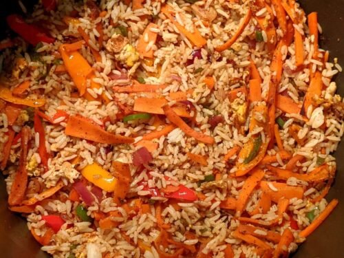 Fried rice with vegetables and eggs on a pan