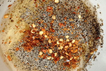 Raw egg with spices added in a bowl