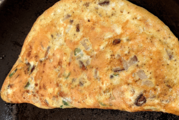 Spicy egg omelette in a pan