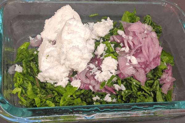 Chopped gotu kola leaves, chopped pearl onions and a cup of shredded coconut
