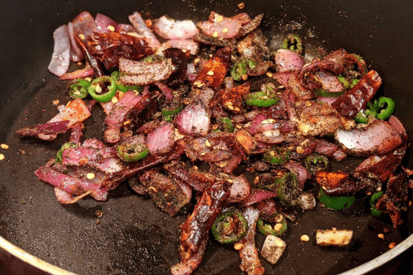 chopped vegetables with roasted spices on a pan