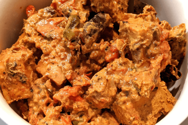 dry paneer curry on a white dish