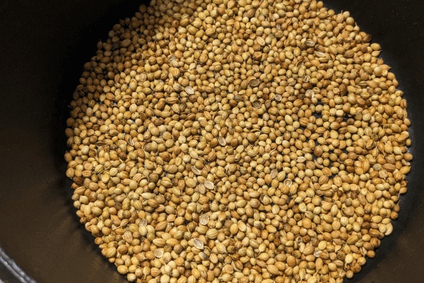 roasted kothamalli or coriander seeds in a pan